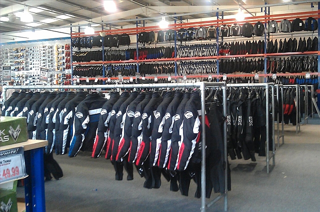 the inside of george whites showing a big shop with racks full of bike jackets and motorcycle clothing